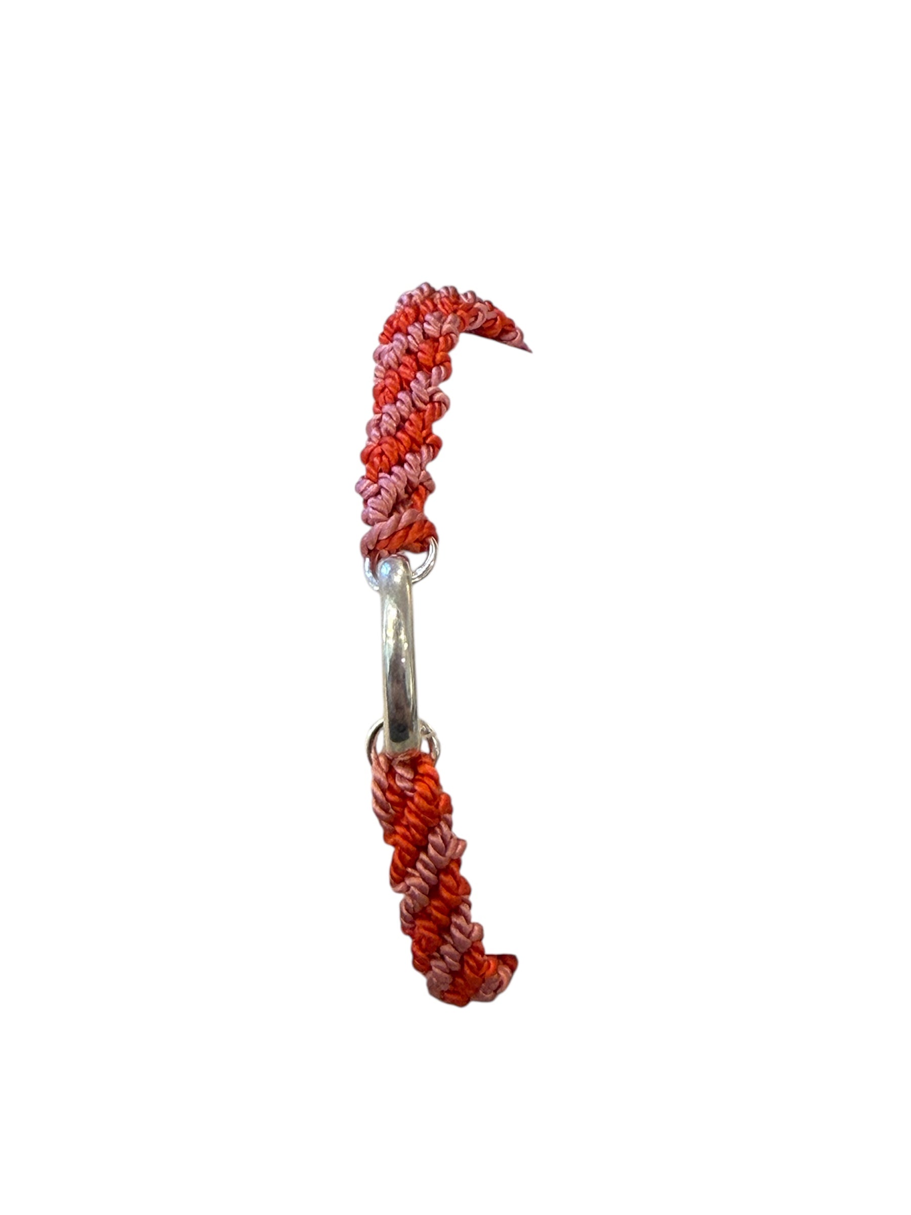 Pink and Red, candy striped friendship bracelet with a silver oval clasp.