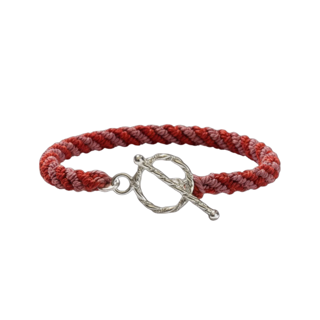 Red braided friendship bracelet with a silver clasp on a white background